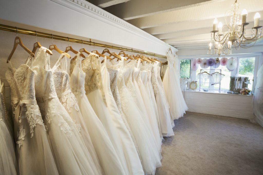 Rows of wedding dresses on display in a specialist wedding dress shop. Bridal Boutique.
