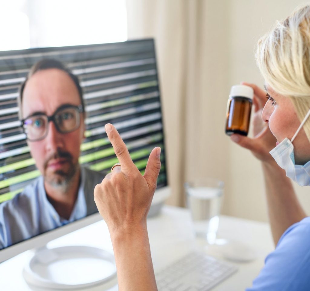 Woman doctor having video call with patient on laptop, online consultation concept