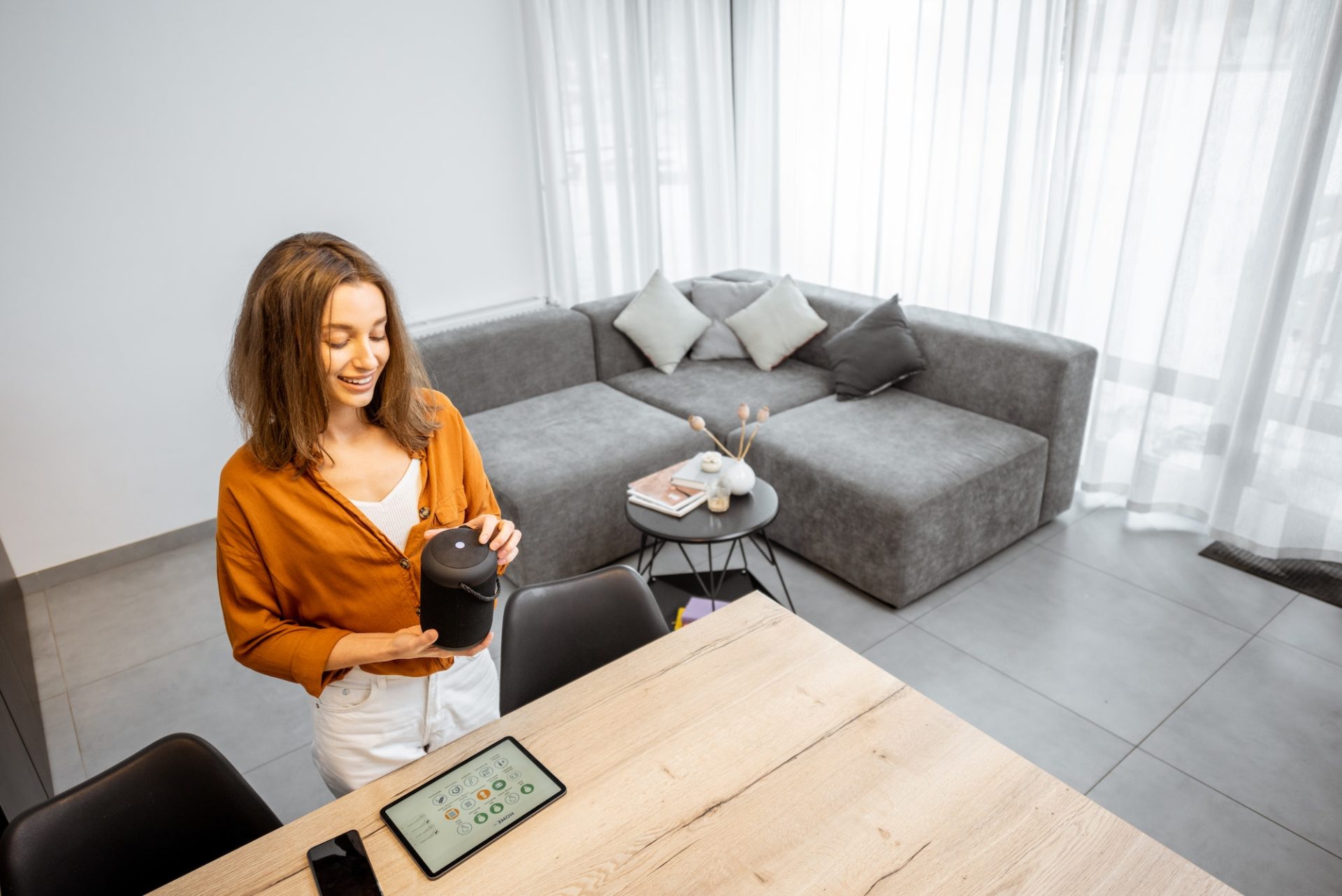 Woman with digital devices for smart home control