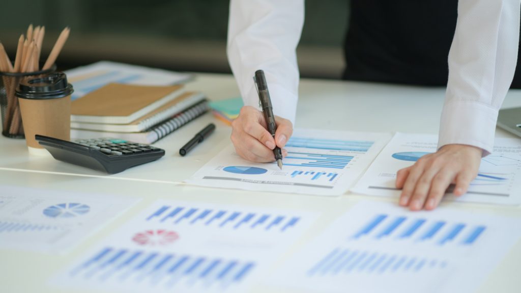 New generation of business professionals analyze their investment plans with charts and graphs.