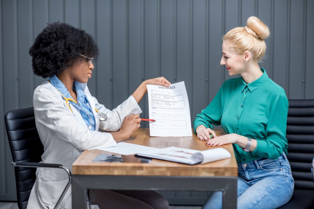 Doctor with medic insurance document