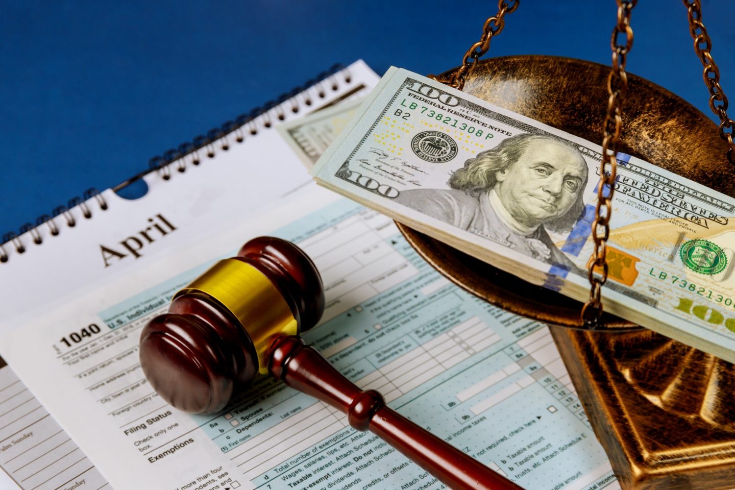 Law concept scales of justice criminal liability for non-payment of taxes of one hundred dollars