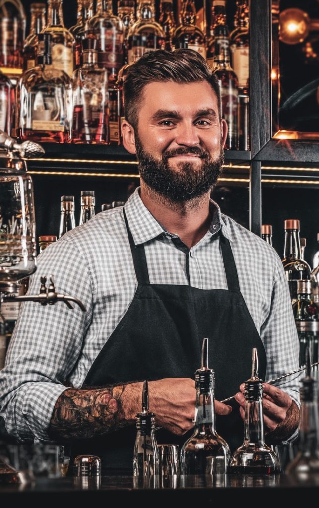 Handsome barman is posing for photographer
