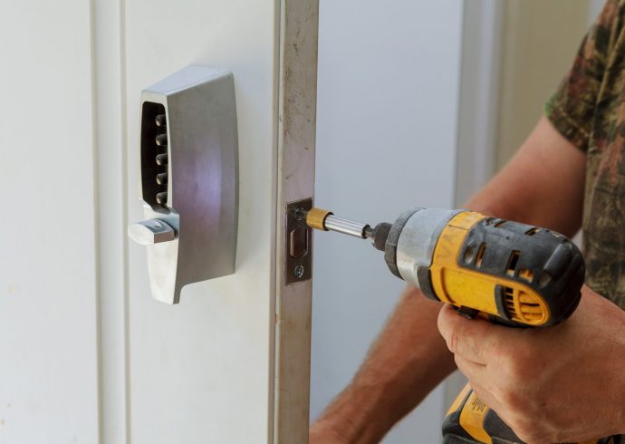 Man installing of the door with lock key security