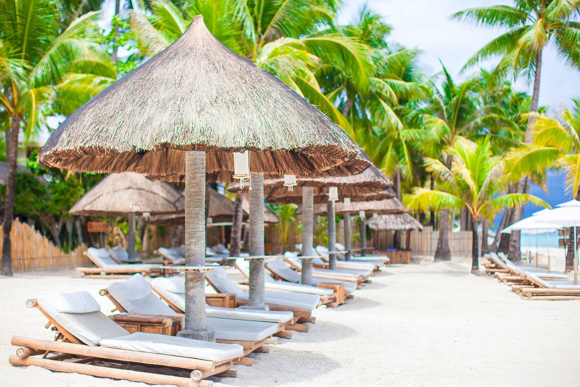 Beach beds on luxury resort on exotic tropical white sandy beach