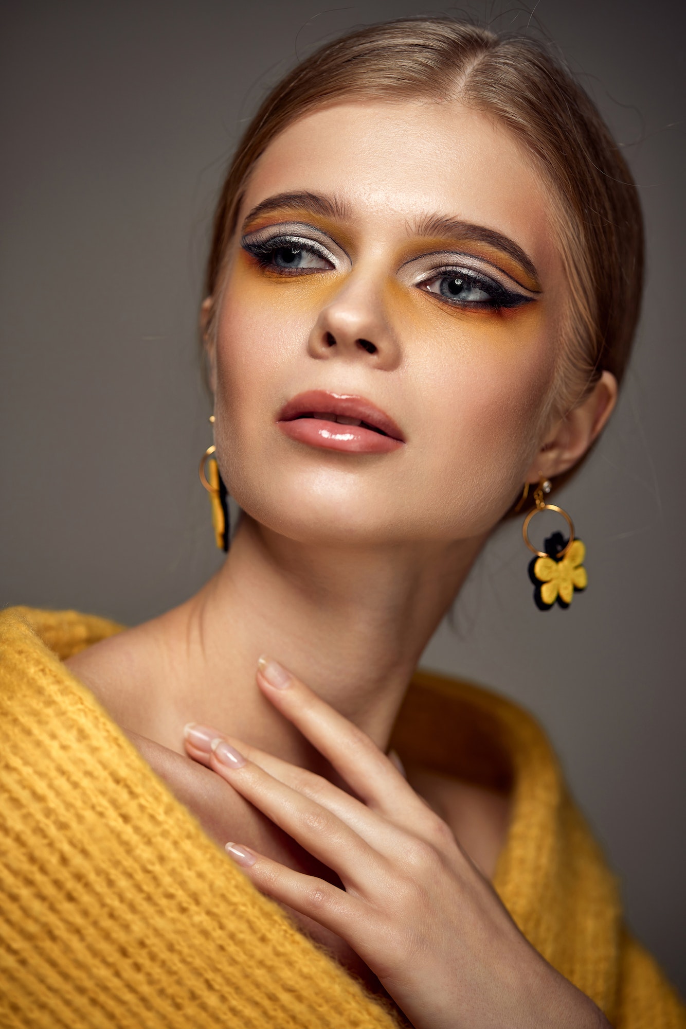 Beauty blonde model girl with fashionable creative make-up
