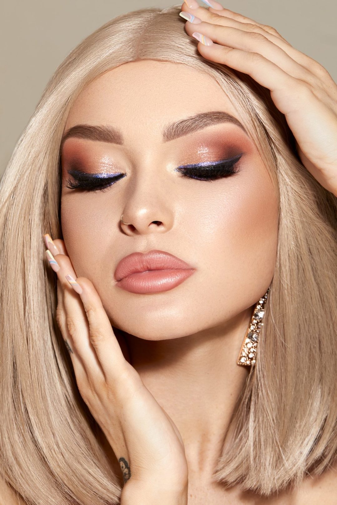 Vertical shot of a gorgeous attractive blonde female model with glam makeup