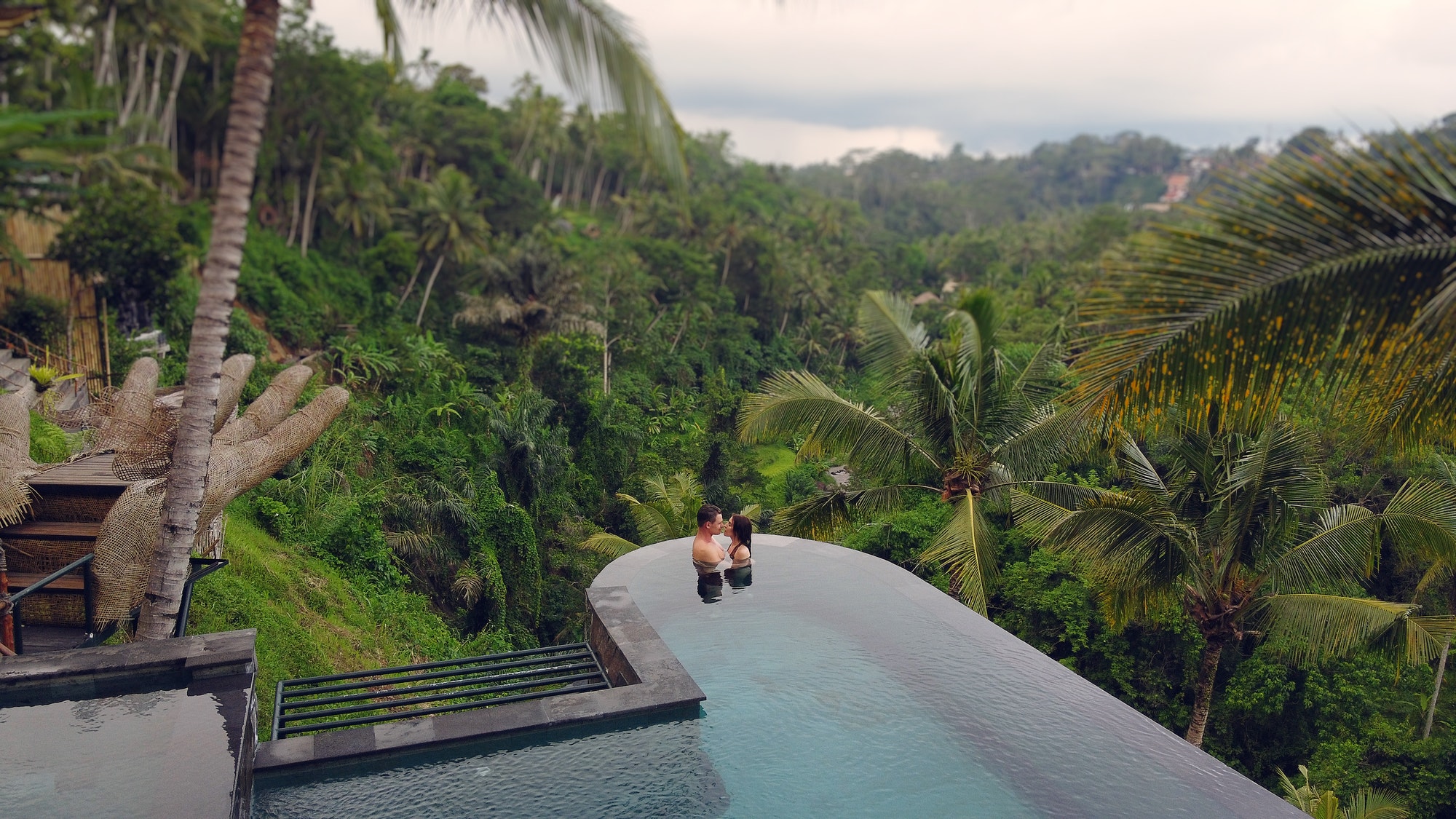 Couple in a swimming pool on a jungle view