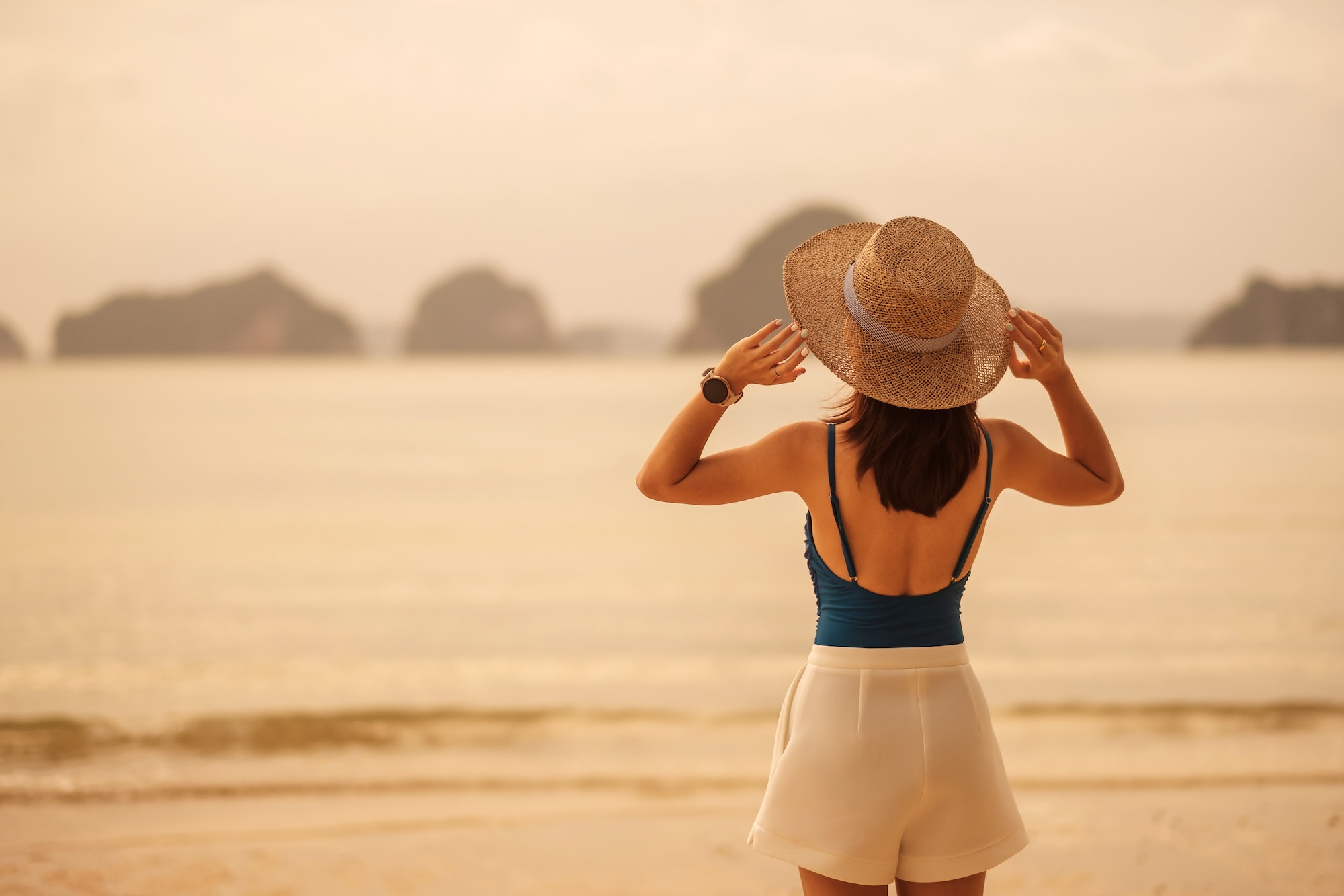 Woman tourist walking at Paradise beach on Islands at sunset. destination, wanderlust, Asia Travel