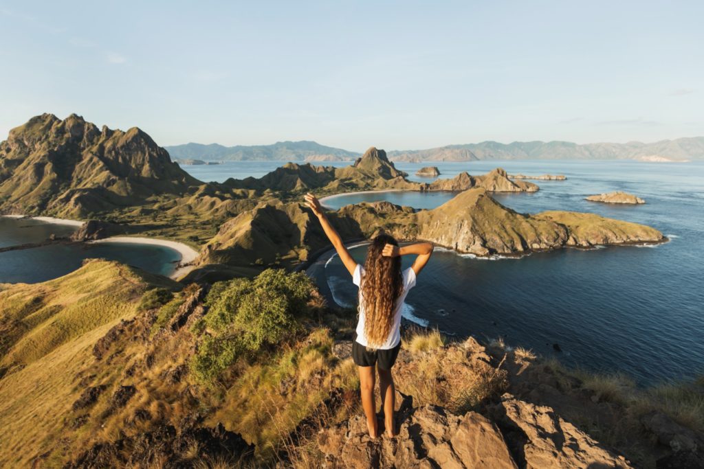 Woman with amazing view of Padar island in Komodo national park, Indonesia. Enjoying tropical
