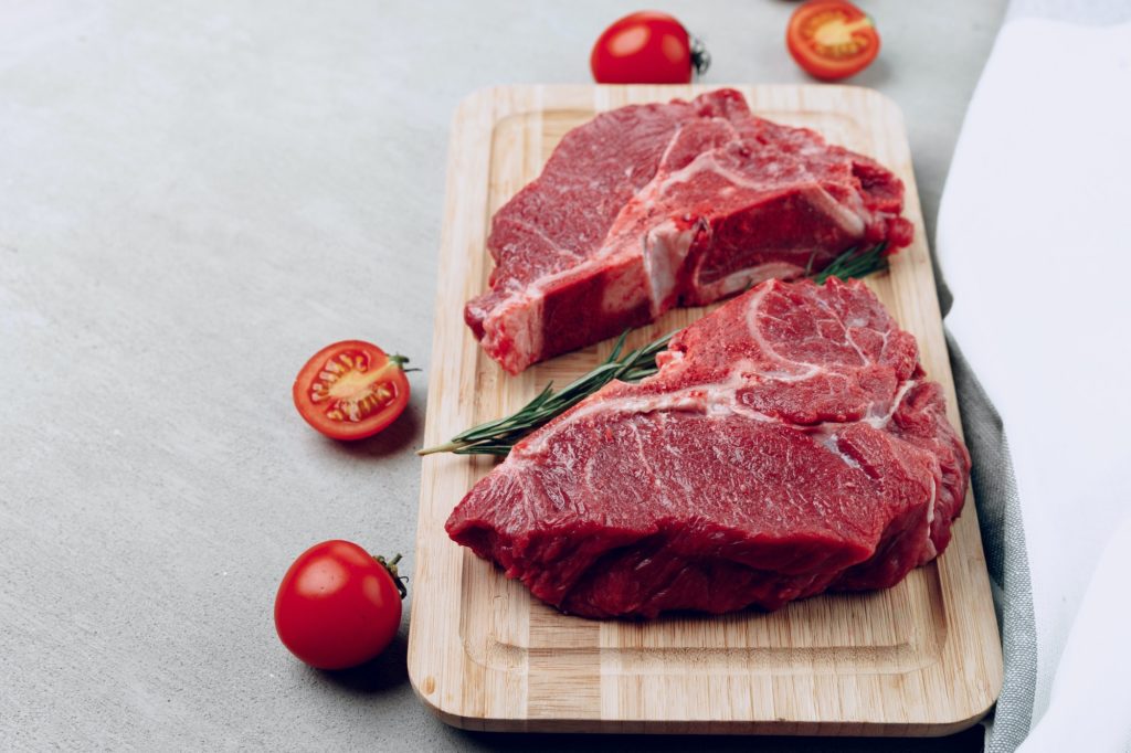 Raw beef meat fillet on wooden board