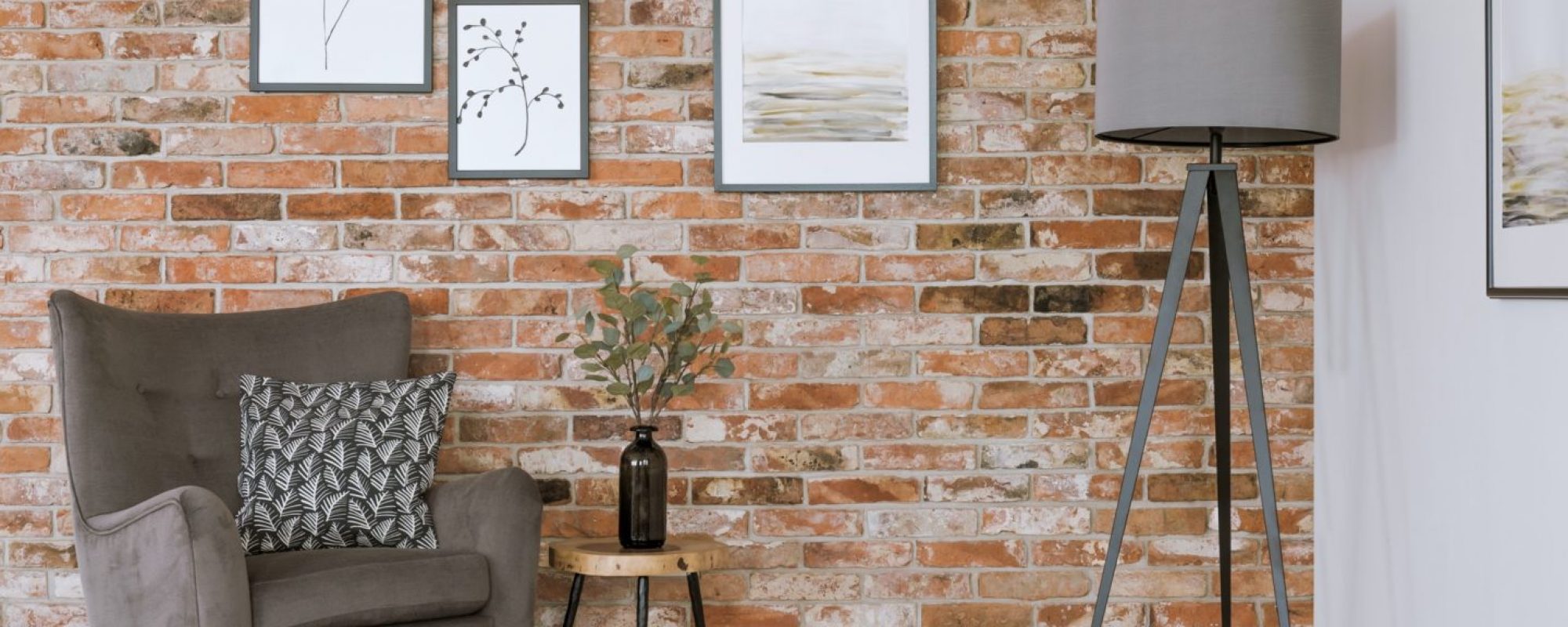 Gray furniture against brick wall