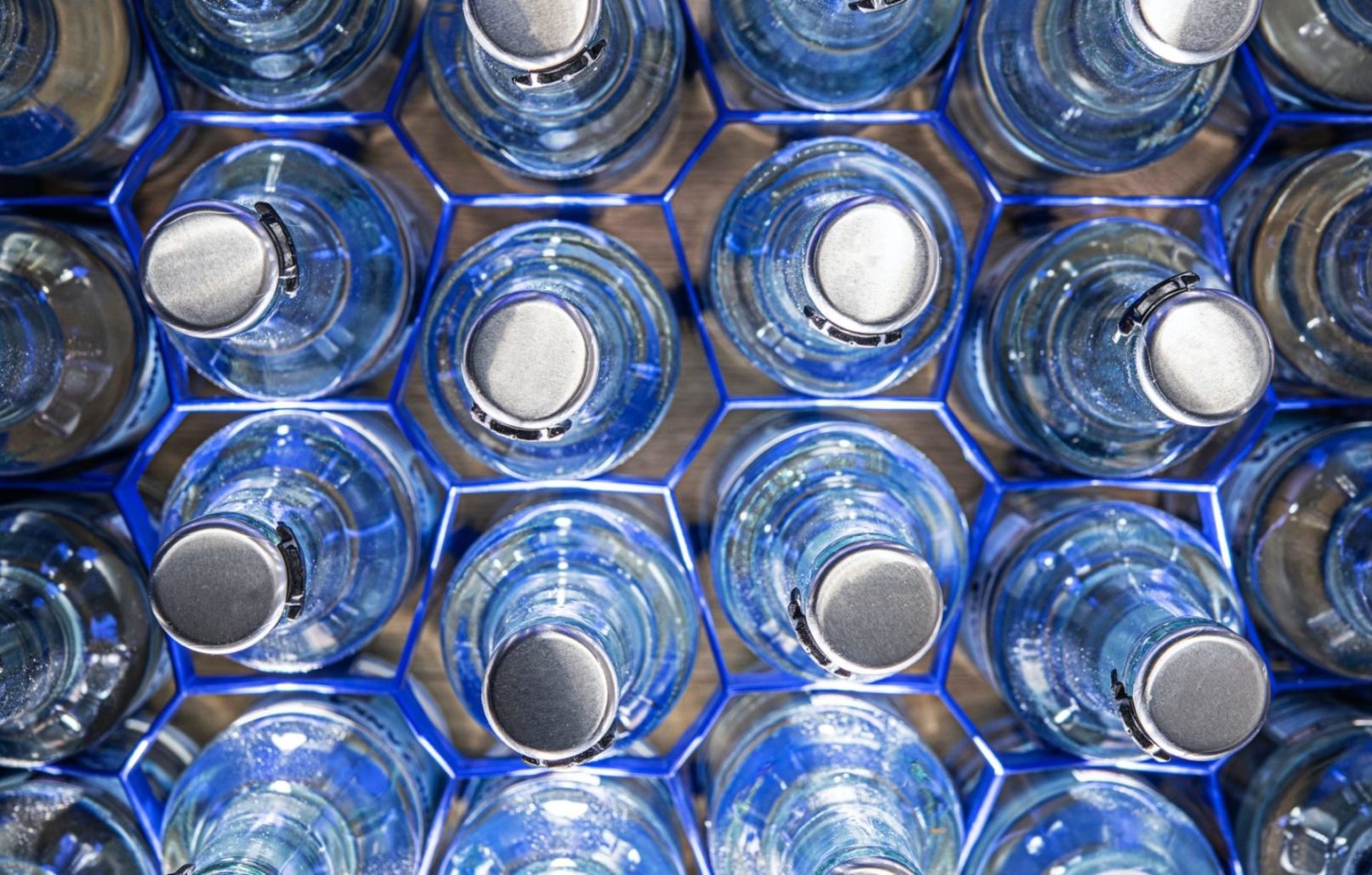 Clear Glass Water Bottles In Holders.