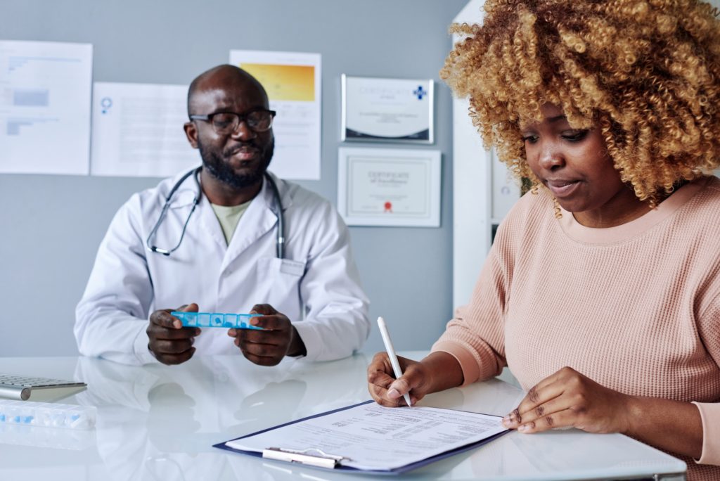 Woman signing insurance before treatment