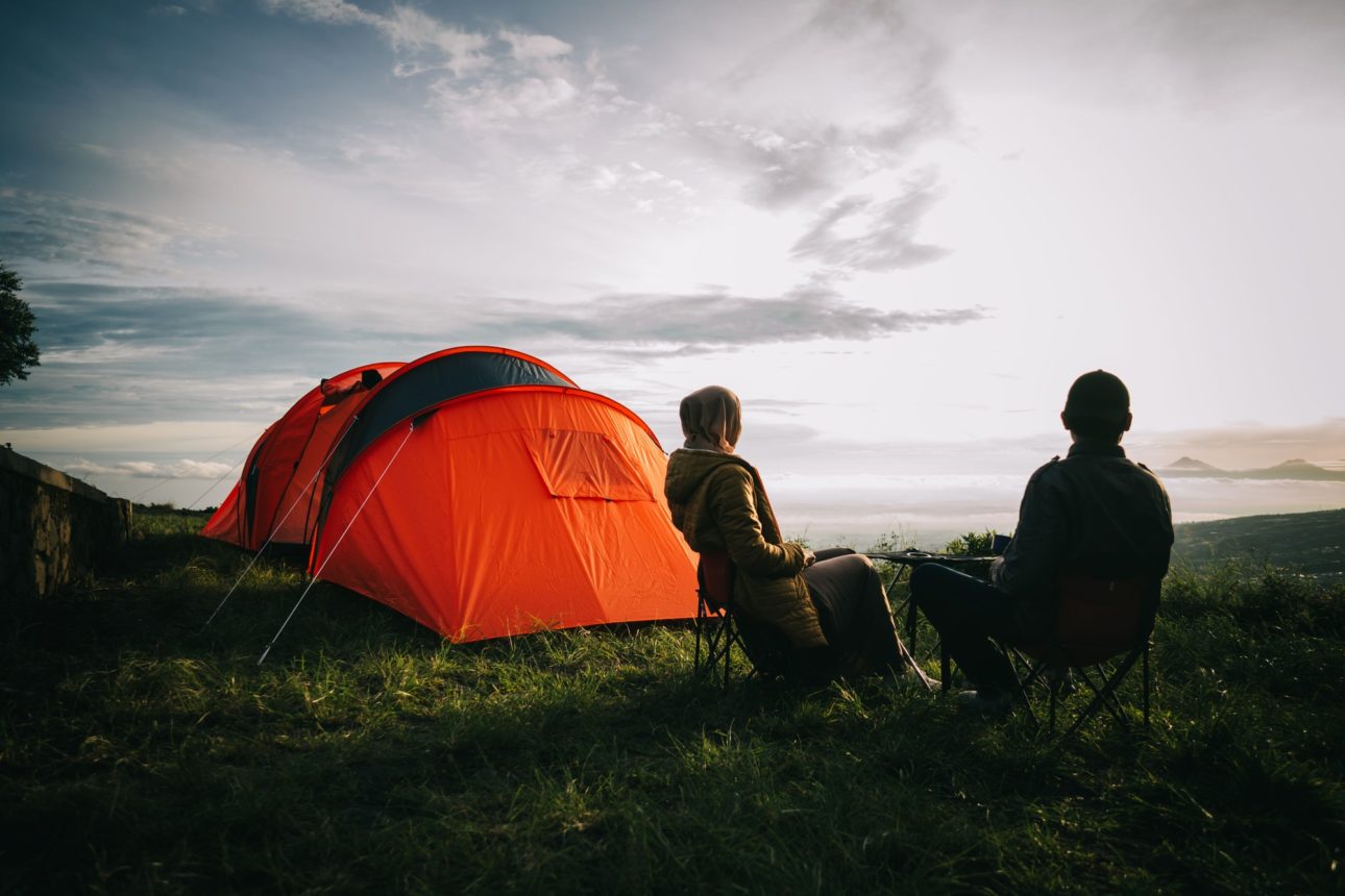 Asian couple camping with sunrise view in mountain