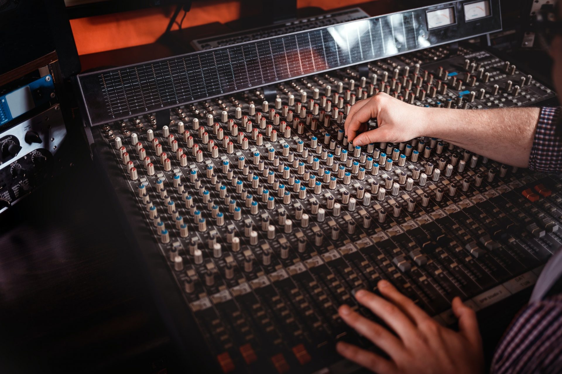 Recording studio mixing desk, music producer using soundboard