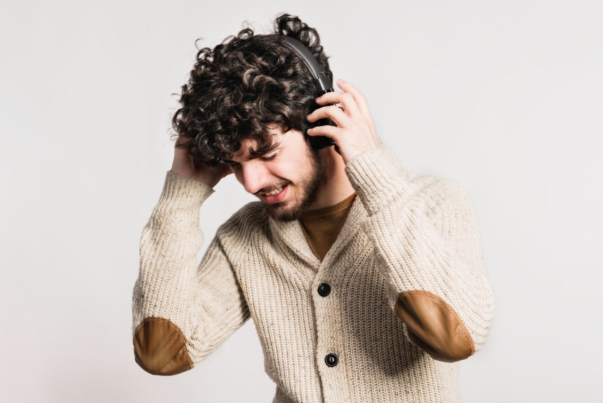 Portrait of a young man with headphones in a studio.
