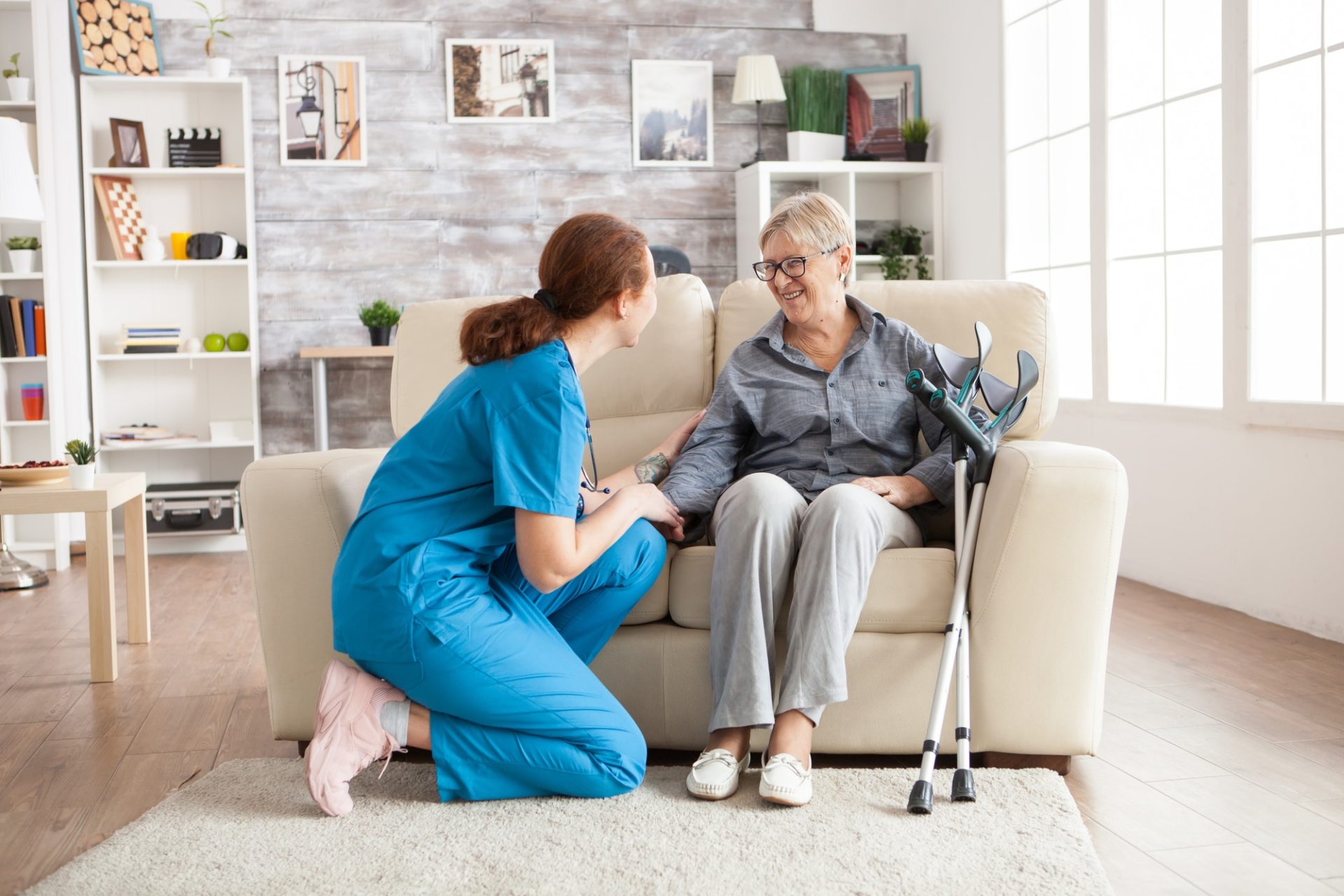 Female nurse talking with an old woman