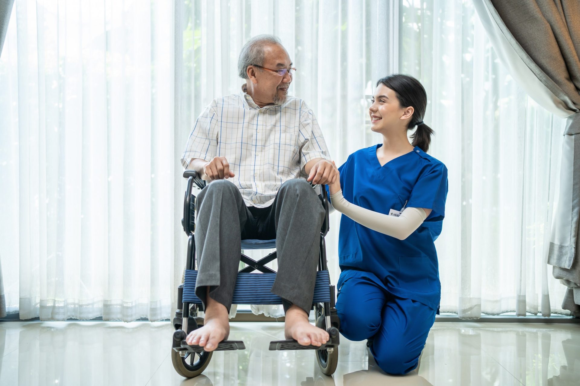 Portrait of Happy Asian disabled Senior Elderly male on wheelchair enjoy stay home nursing care.