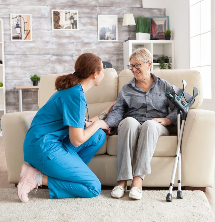 Female nurse talking with an old woman