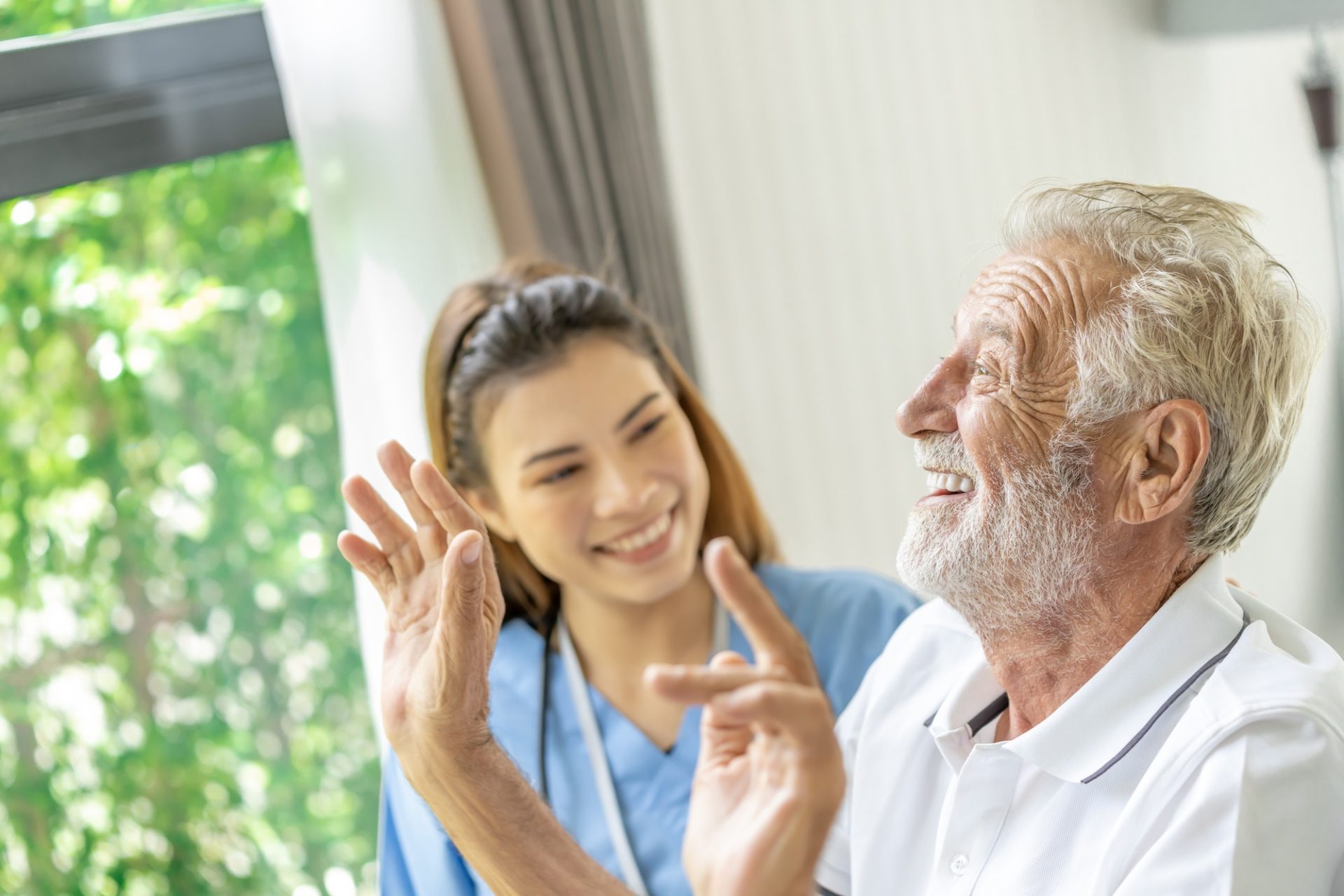 Man being cared for by a private Asian nurse at home