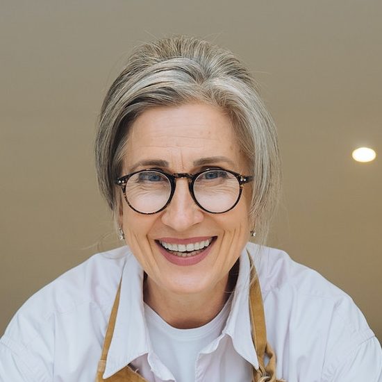 Smiling middle aged mature grey haired woman looking at camera
