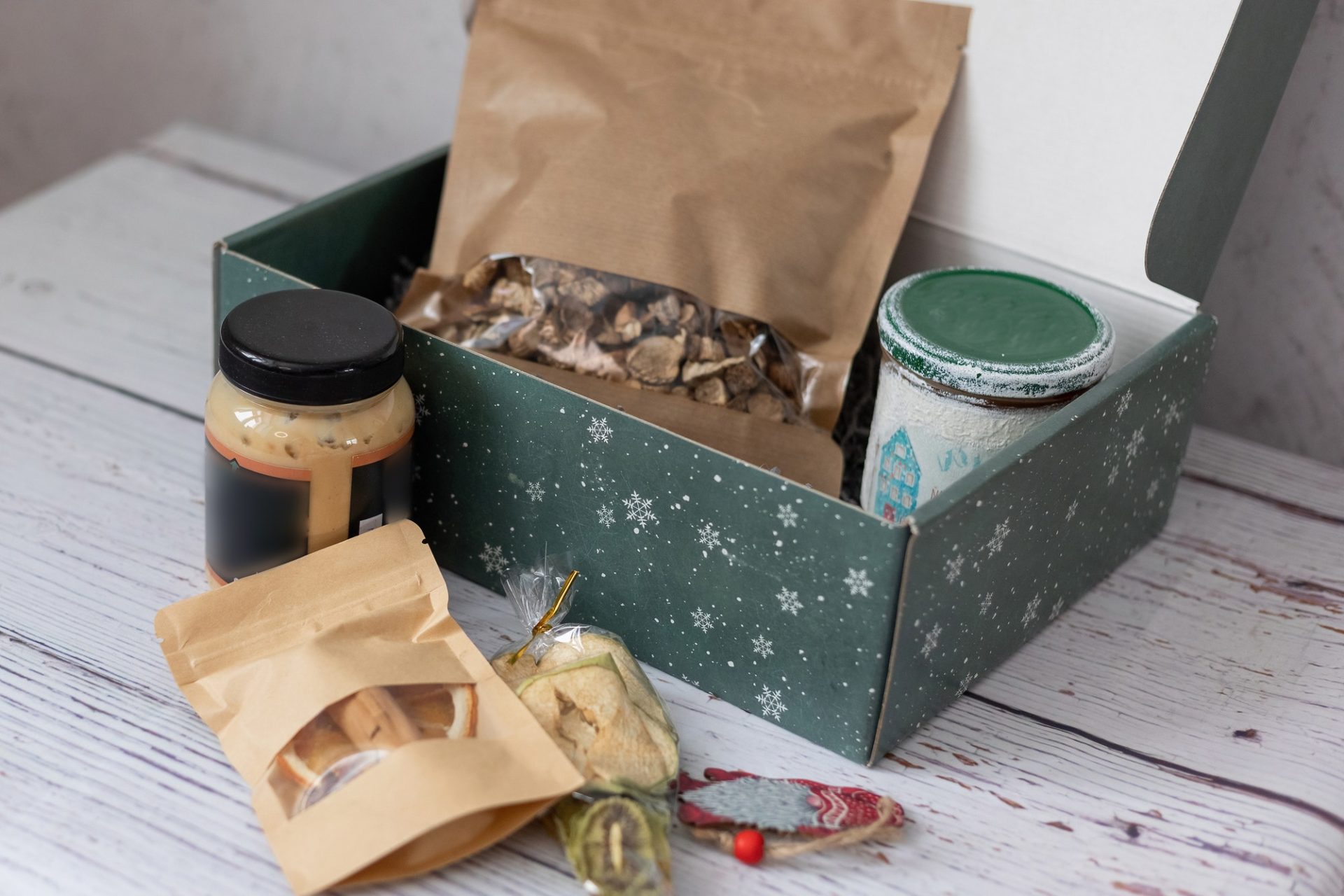 The idea of packaging and gift. A box for an autumn or winter gift with sweets and dried vegetables,
