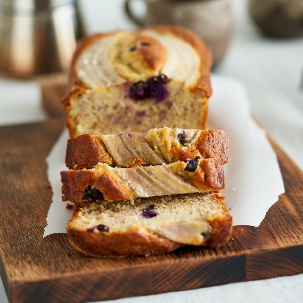 Banana bread, slice of cake with banana and blueberries. Morning breakfast with coffee