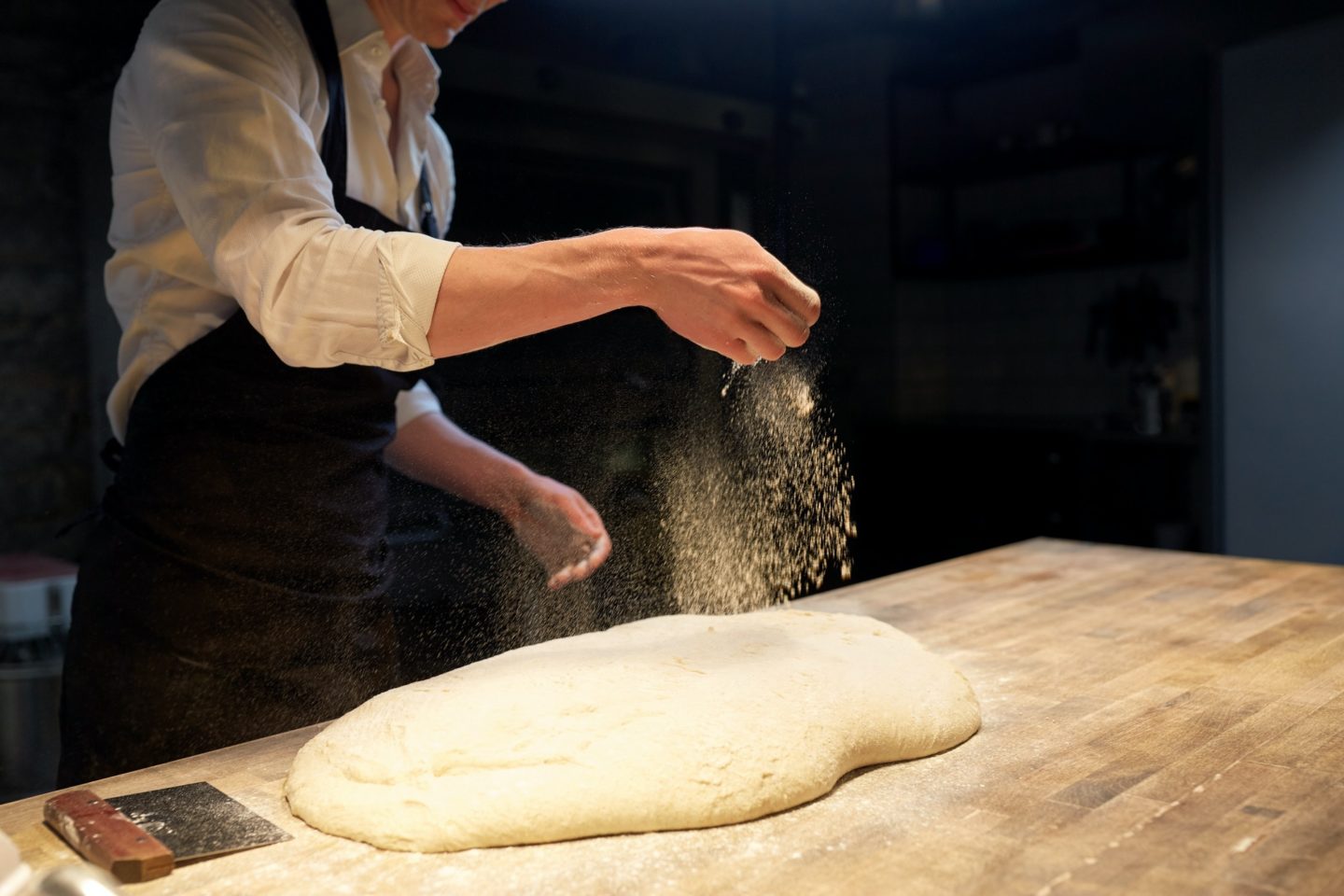 chef or baker making bread dough at bakery
