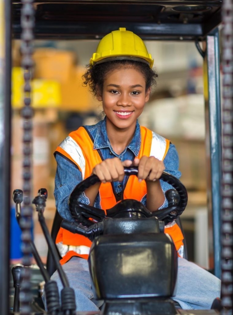 women worker at forklift driver happy working in industry factory logistic ship.