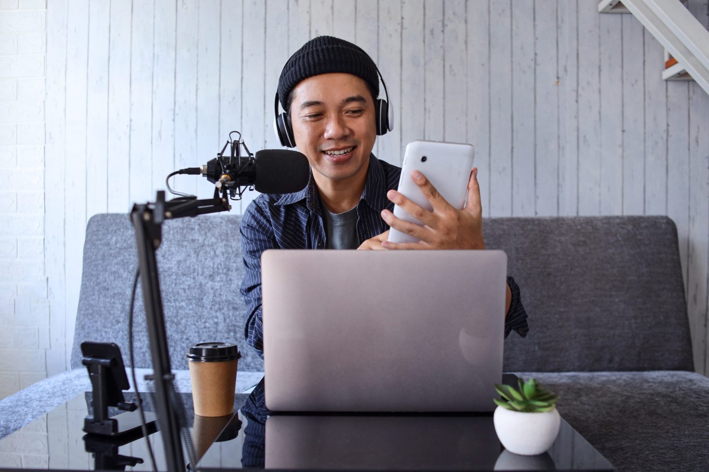 Asian man recording a podcast