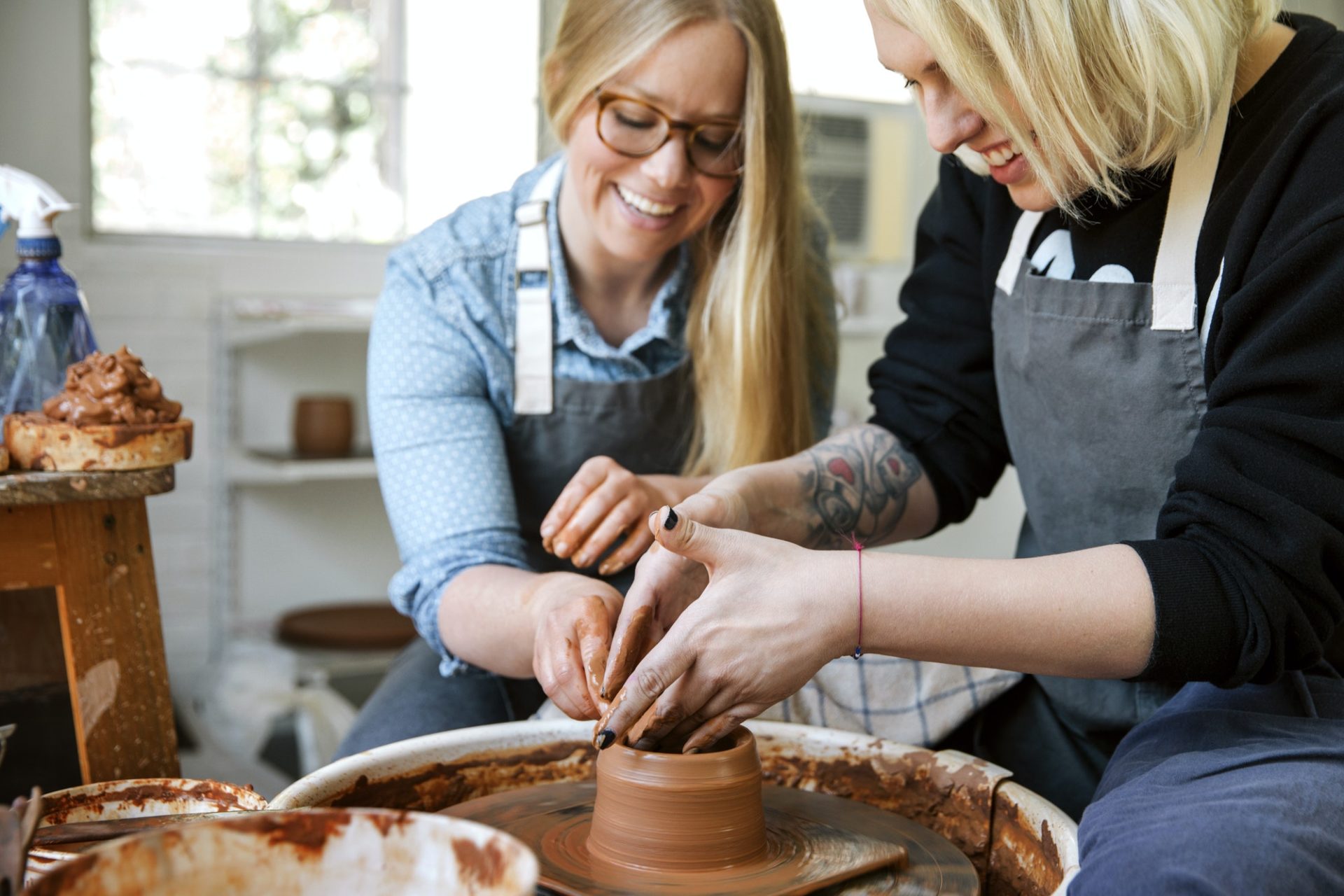 Happy Women Working On Pottery Wheel In Workshop