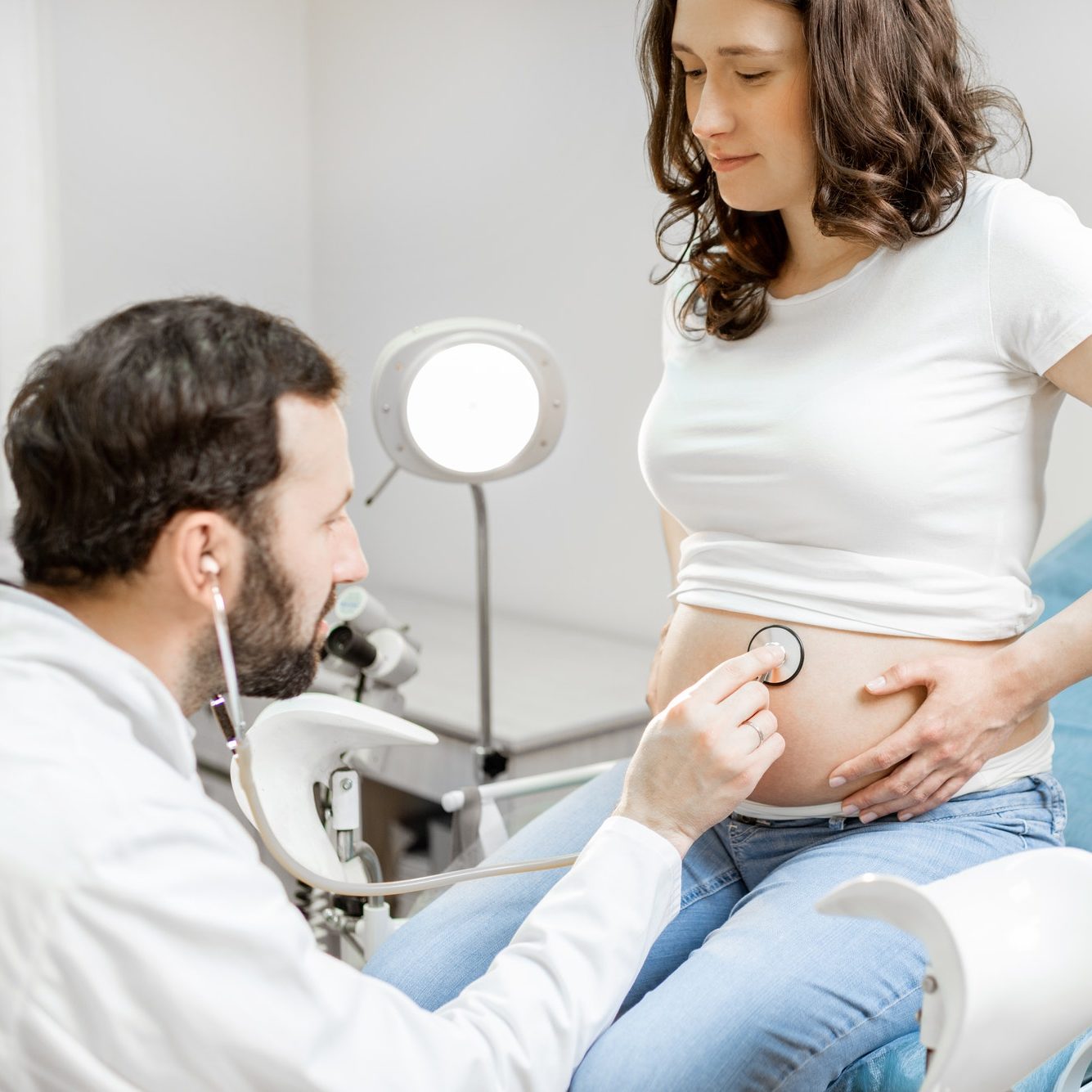 Doctor listening to a pregnant woman's belly