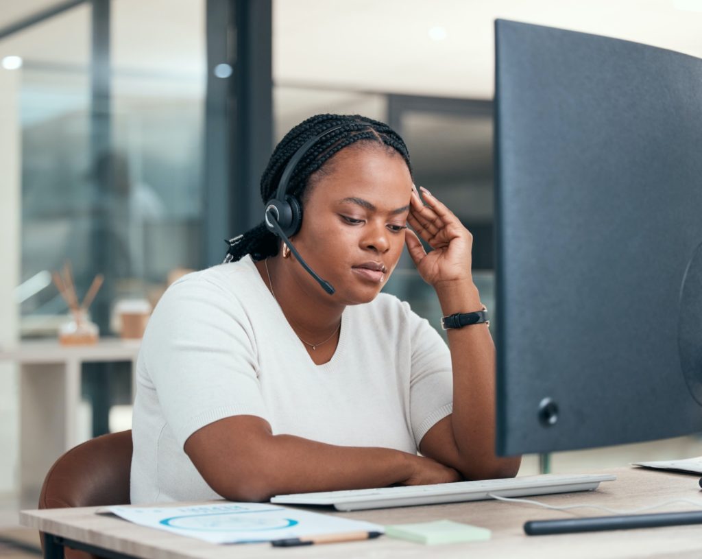 Stress, anxiety and burnout with a woman consultant working in a call center for customer care and