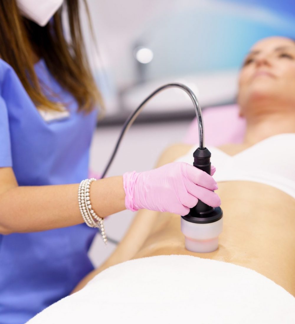 Woman receiving anti-cellulite treatment with radiofrequency machine in a beauty center