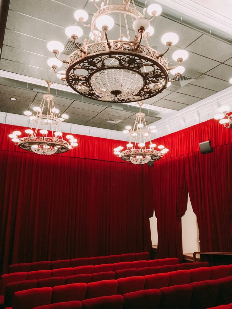 luxury red cinema hall with large beautiful chandeliers