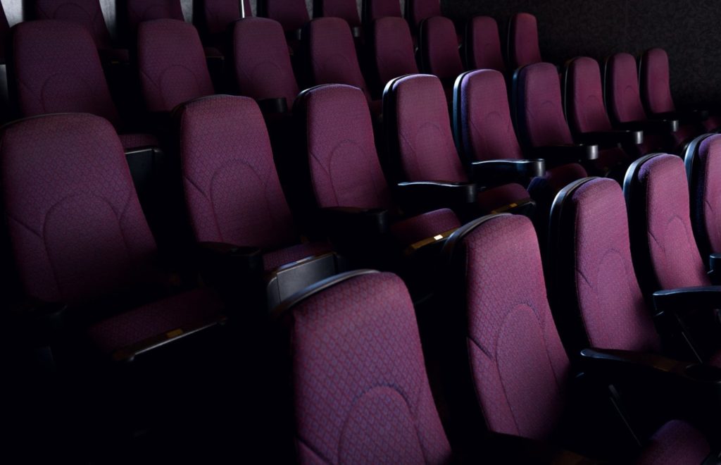 red seats in empty dark movie theater