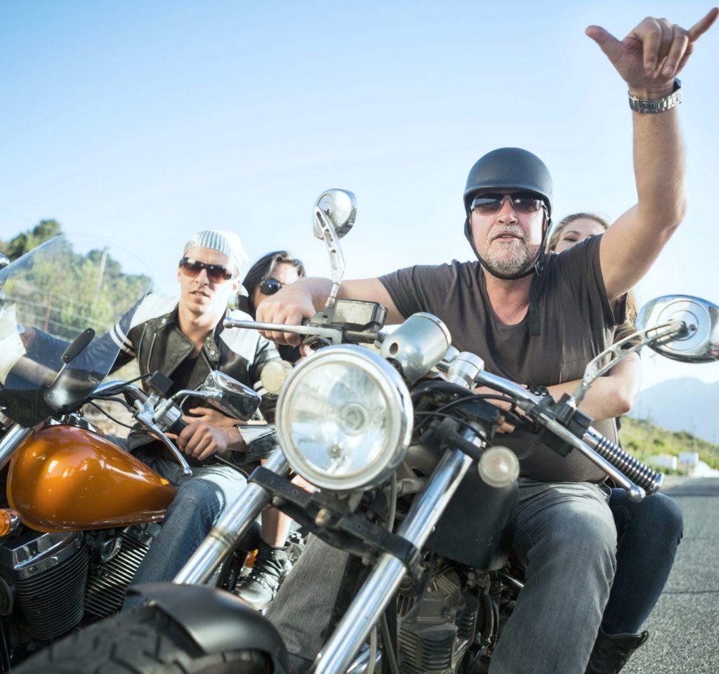 Friends riding motorcycles on open road