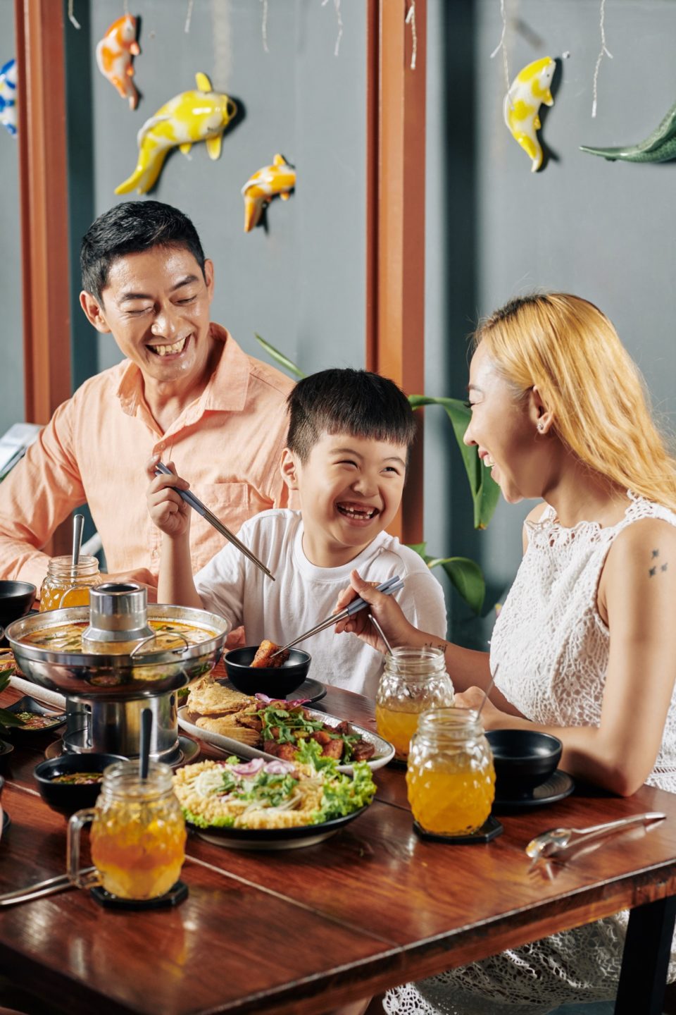 Happy family eating dinner in restaurant