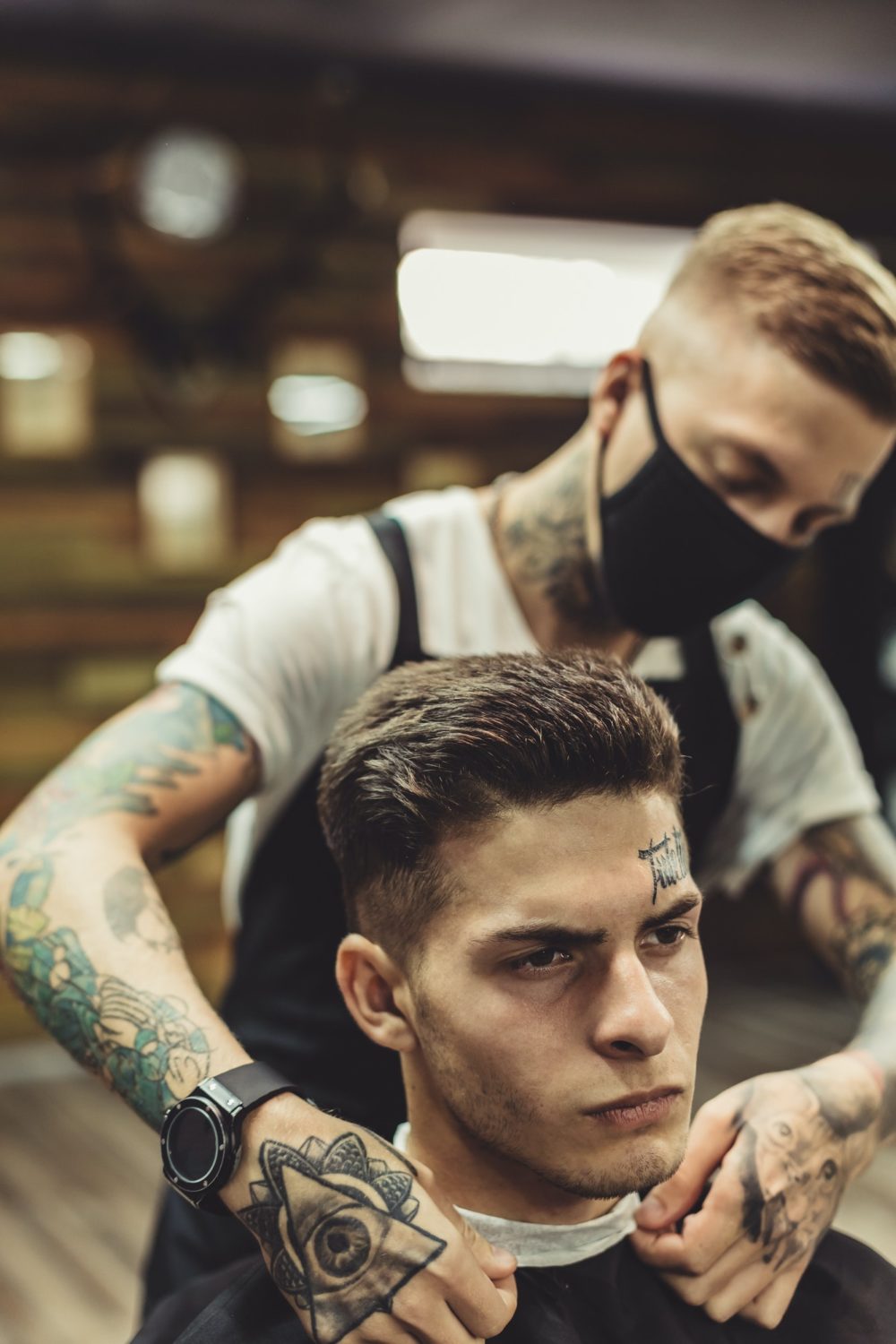 Anonymous barber preparing client