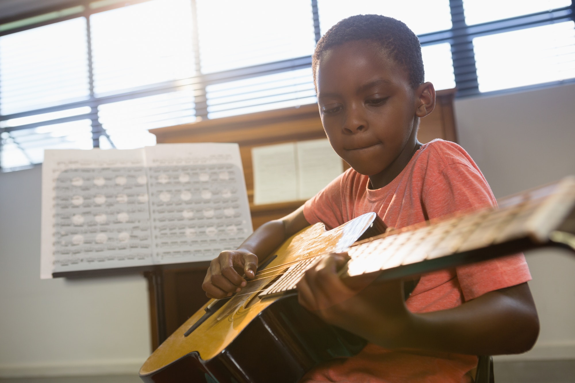 Boy playing guitar in class