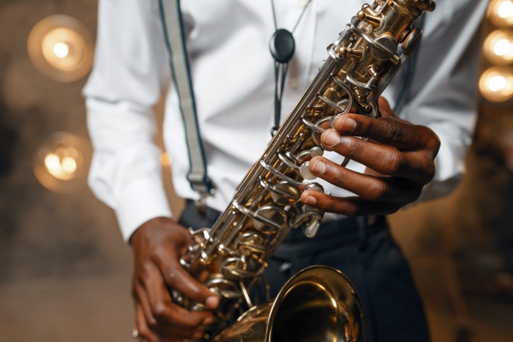 Male jazz performer plays the saxophone on stage
