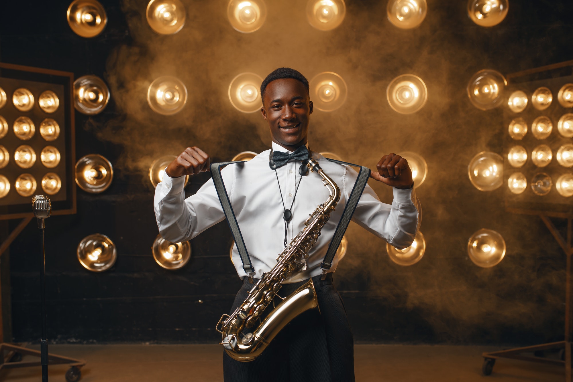 Smiling jazz performer with saxophone on stage
