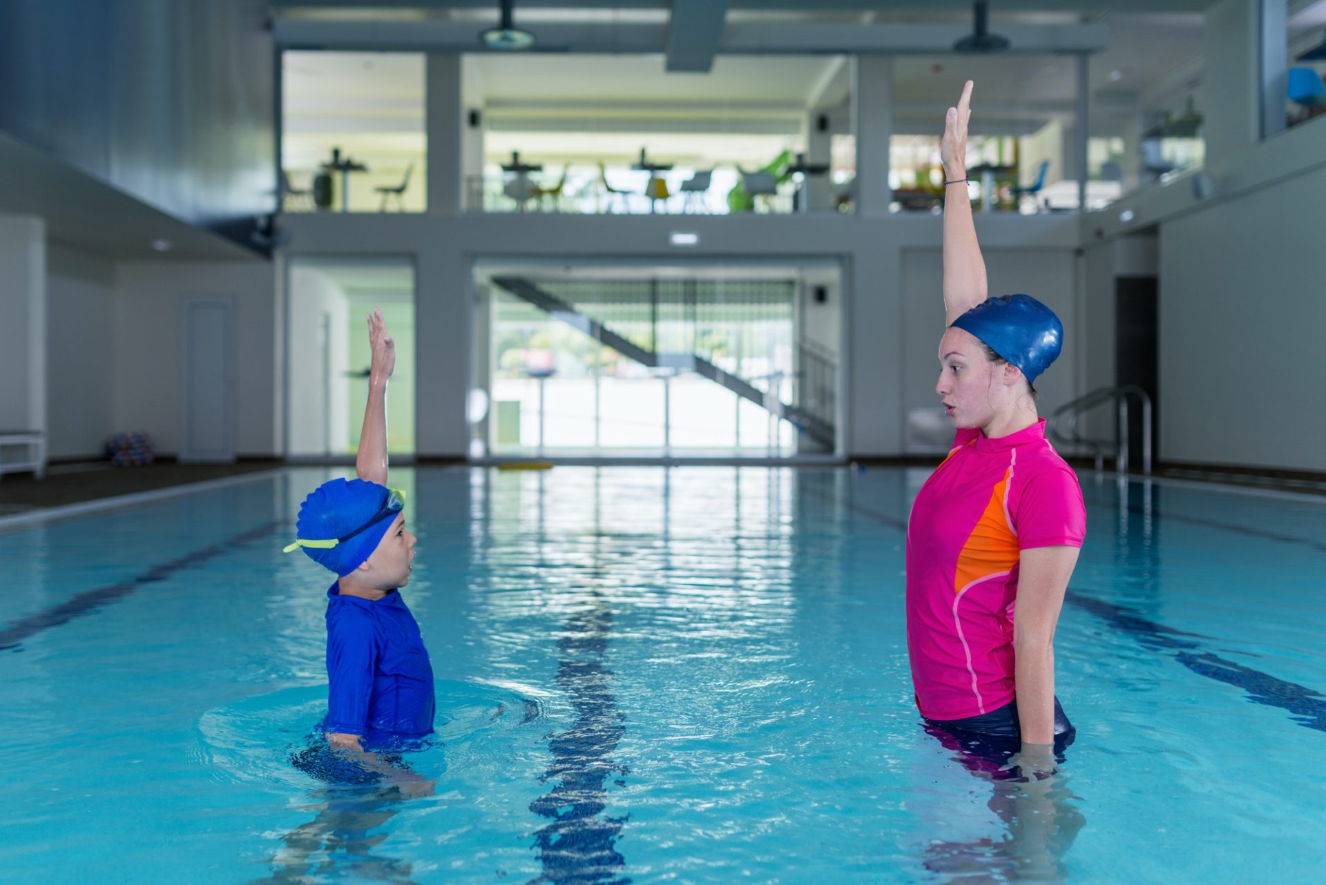 Swimming lesson. Cute little boy learning to swim with swimming