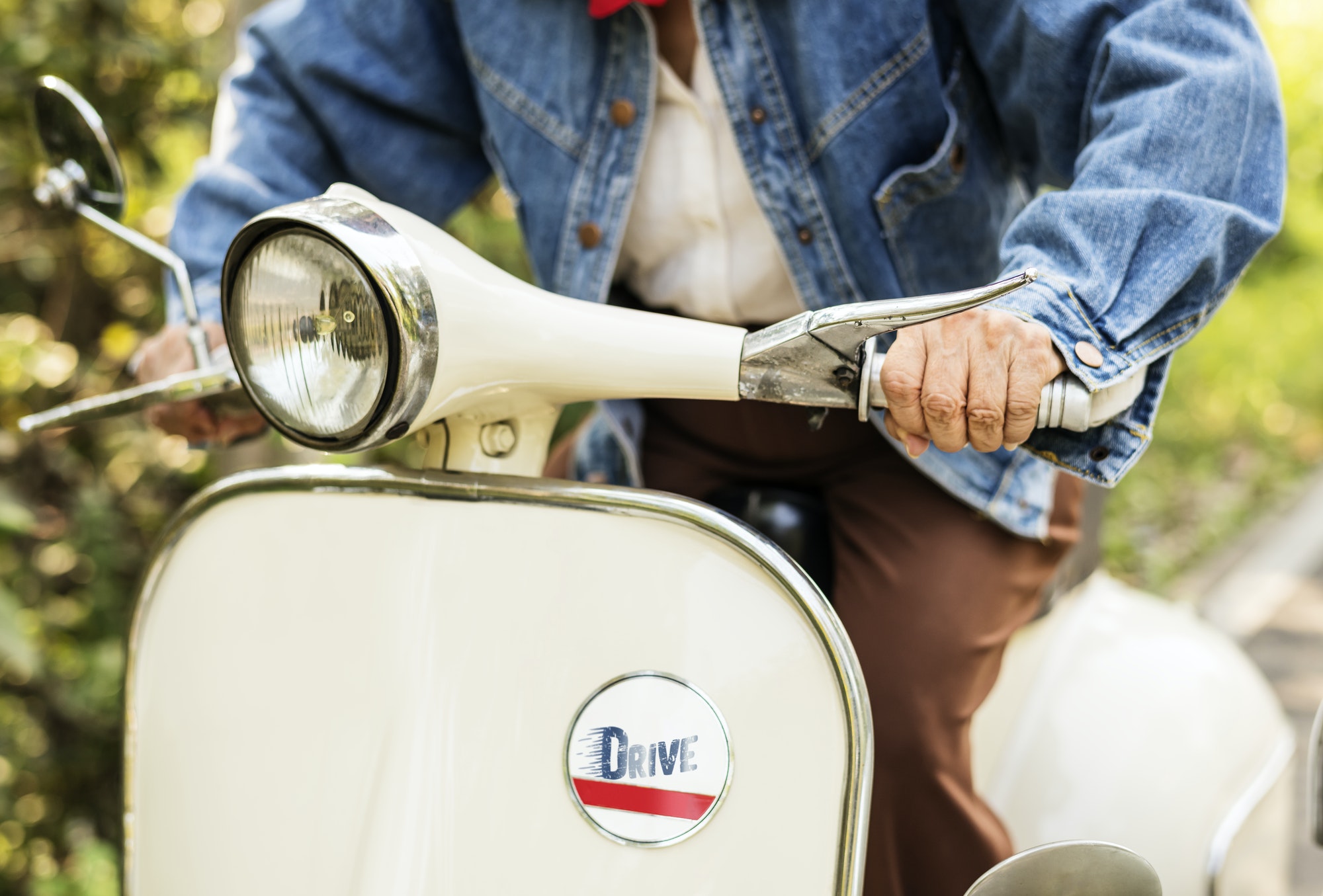 Closeup of a woman riding a classic scooter