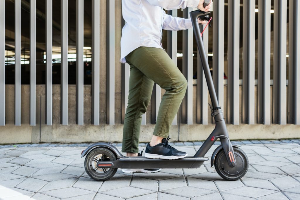 Woman on electric kick scooter