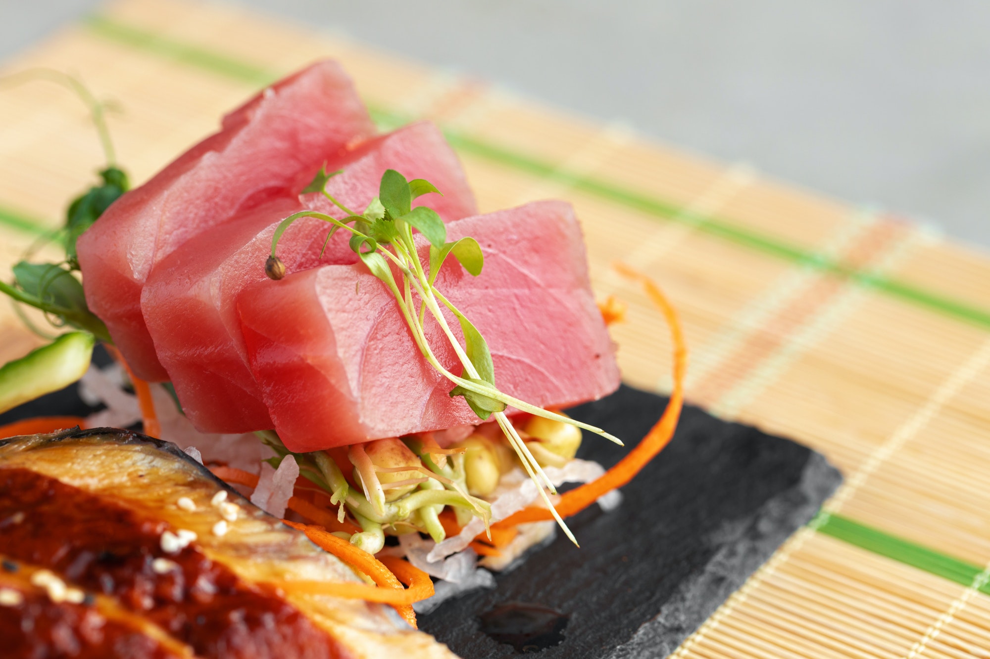 Sashimi sushi served on stone plate close up
