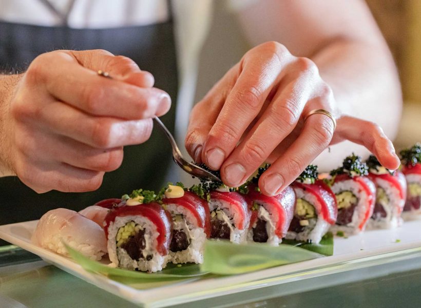 chef-s-hands-decorating-traditional-japanese-sushi