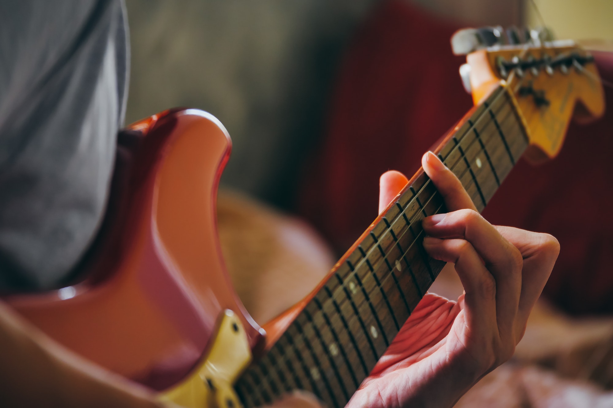 Close up of male hands playing electric guitar. Selective focus