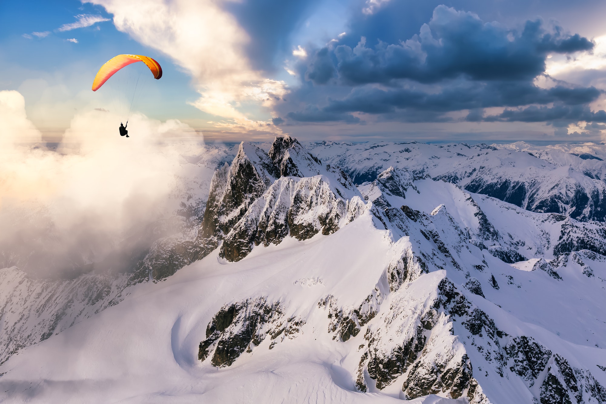 Paraglider Flying up high in the Rocky Mountains